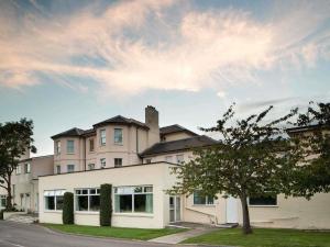 a large white building on the side of a street at Mercure Maidstone Great Danes Hotel in Maidstone