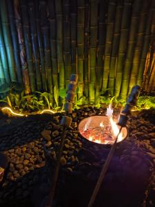 a fire pit with bamboo in the background at Cabana recanto da TOCA in Ilhabela