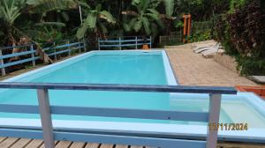 a swimming pool with a blue pool at DOMAINE de VALCINE 3 gites parc et piscine à 4 mn de la distillerie DBM, des 1er commerces et de la cascade de BIS in Sainte-Rose