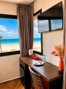 a desk in a room with a view of the beach at Oceana Mazagan Suites Hôtel in El Jadida