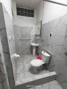 a bathroom with a toilet and a sink at Casa El Capulí in Cajamarca +52 photos