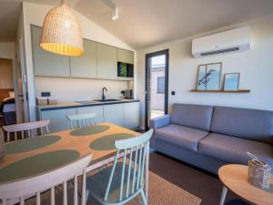 a kitchen and a living room with a table and a couch at Guesthouse Seeblick in Breitenbrunn +13 photos