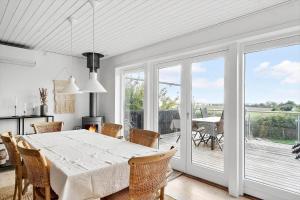 a kitchen and dining room with a table and chairs at 7032-Bogo-Kvaernen-32 in Gammelby