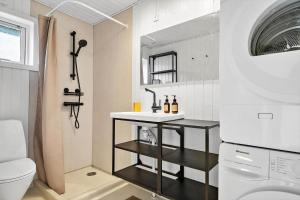 a small bathroom with a sink and a toilet at 7032-Bogo-Kvaernen-32 in Gammelby