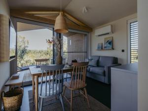 a kitchen and living room with a table and chairs at Guesthouse Leithagebirge in Breitenbrunn +13 photos