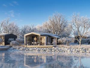 a house on the water in the snow at Guesthouse Leithagebirge in Breitenbrunn