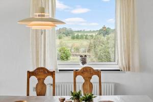 a table with two chairs in front of a window at 4035-Borre-Bogebjergvej-15 in Borre