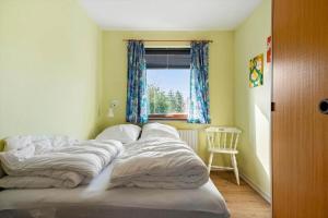 a large bed in a room with a window at 4035-Borre-Bogebjergvej-15 in Borre