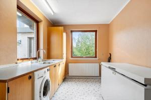 a kitchen with a washing machine and a window at 4035-Borre-Bogebjergvej-15 in Borre +24 photos