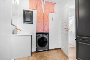 a laundry room with a washer and dryer in it at 8119-Praesto-Over-Lyngen-19 in Præstø