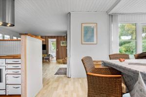 a kitchen and dining room with a table and chairs at 1111-Stege-Ulvshalevej-111 in Stege