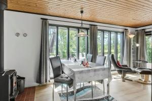 a dining room with a table and chairs in a room at 7041-Bogo-By-Tarnbakken-21 in Bogø By