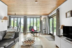 a living room with a couch and a chair at 7041-Bogo-By-Tarnbakken-21 in Bogø By