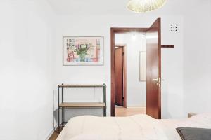 a white bedroom with a bed and a mirror at 2007-Stege-Aedelgranen-3 in Stege
