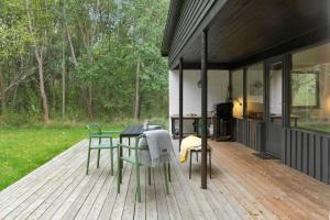a patio with a table and chairs on a deck at 2007-Stege-Aedelgranen-3 in Stege