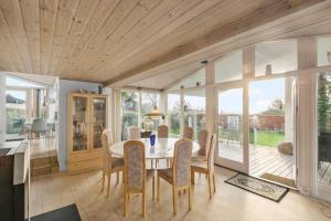 a dining room with a table and chairs at R623-Rodvig-Laurasvej-13 in Rødvig +16 photos