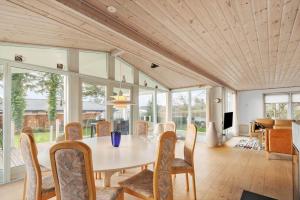 a dining room with a table and chairs at R623-Rodvig-Laurasvej-13 in Rødvig