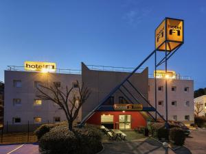a hotel with a sign in front of a building at hotelF1 Mulhouse Bâle Aéroport in Saint-Louis
