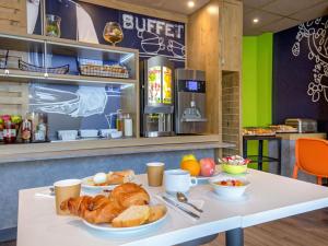 a table with bread and croissants on it at Ibis Budget Marseille Timone in Marseille