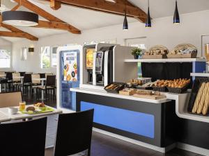 a bakery with a counter with bread and pastries at Ibis budget Chambéry Centre Ville- Hôtel Rénové in Chambéry +72 photos