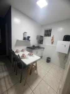 a small kitchen with a table and chairs in it at kit net central 1 in Serra Negra