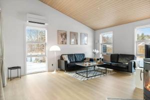 a living room with a couch and a table at HA364-Hals-Hou-Mose-19 in Hals