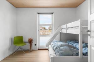 a bedroom with a bunk bed and a green chair at HA364-Hals-Hou-Mose-19 in Hals +27 photos