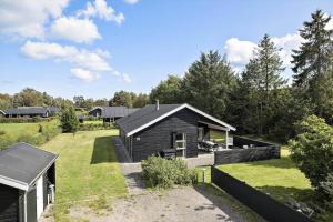 a black house with a garden and a yard at HA364-Hals-Hou-Mose-19 in Hals