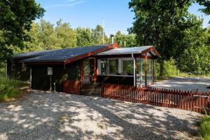 a small building with a fence next to a road at HA378-Saeby-Krebsevej-2 in Sæby +16 photos