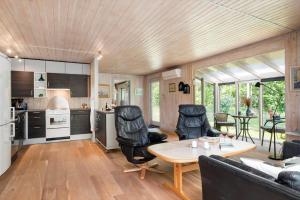 a kitchen and living room with a table and chairs at HA378-Saeby-Krebsevej-2 in Sæby
