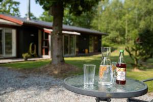 a table with two glasses and a bottle on it at HA378-Saeby-Krebsevej-2 in Sæby
