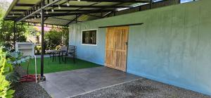 a patio with a wooden door and a table at Elegant studio in Fortuna