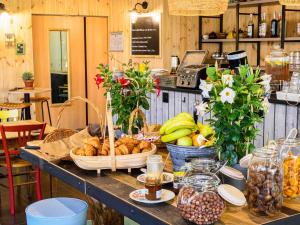 a table with baskets of bread and fruit on it at Greet Hotel Evreux Centre - Route de Normandie by Accor in Évreux