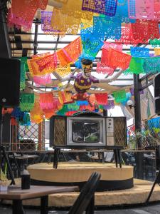 a tv sitting on a table in a room with colorful flags at Casa Pepe in Mexico City