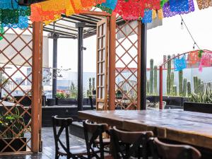 a table and chairs in a restaurant with a view at Casa Pepe in Mexico City