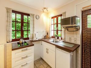 a kitchen with a sink and a microwave at Gorgeous Apartment in Bohon with Garden Furniture and BBQ in Barvaux +65 photos