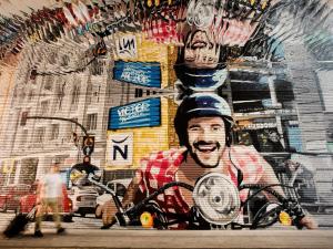 a wall with a painting of a man on a motorcycle at Novotel Madrid Center in Madrid