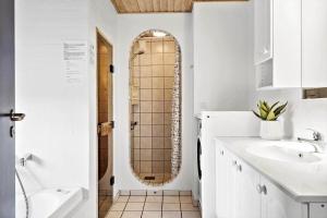 a bathroom with a shower and a sink and a mirror at 380-Harboore-Bethaniavej-9 in Harboør +24 photos