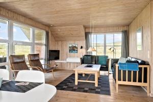 a living room with a couch and a table at 380-Harboore-Bethaniavej-9 in Harboør