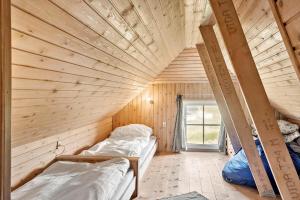 a room with two bunk beds in a wooden house at 380-Harboore-Bethaniavej-9 in Harboør
