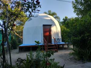 a small white dome tent with a table and a microwave at Domo Premium in Esquina