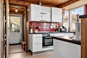a kitchen with white cabinets and a counter top at 4468-Hvide-Sande-Tingodden-427 in Hvide Sande +20 photos