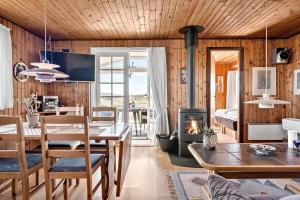 a dining room and living room with a fireplace at 4468-Hvide-Sande-Tingodden-427 in Hvide Sande