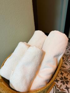 two white towels are sitting in a basket at WORA Home HuaHin in Hua Hin +47 photos