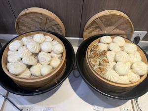 two baskets of donuts sitting on top of a table at Hanting Hotel Shanghai Wujiaochang in Shanghai