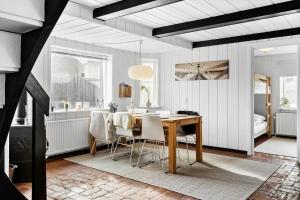 a dining room with a table and chairs at 724-Thyboron-Kirkevej-9 in Thyborøn