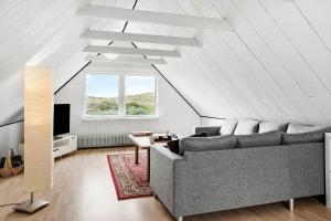a living room with a couch and a tv at 724-Thyboron-Kirkevej-9 in Thyborøn