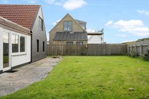 a backyard with a house and a fence at 724-Thyboron-Kirkevej-9 in Thyborøn