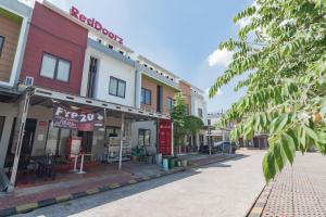 an empty street in a town with buildings at RedDoorz @ Galuh Mas in Karawang
