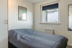 a bedroom with a bed and a mirror at G143-Lemvig-Syrenvej-43 in Lemvig